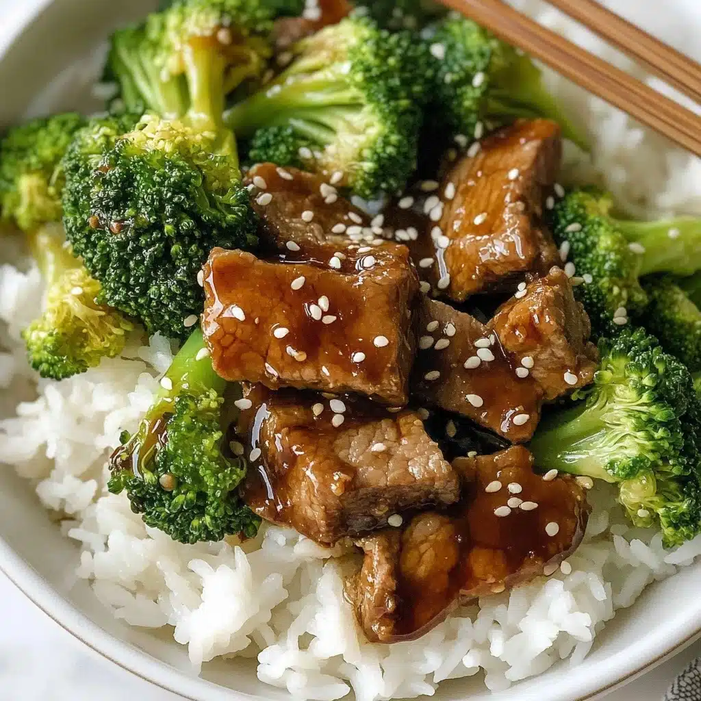 Chinese Beef and Broccoli, Chinese Beef and Broccoli stir-fry, homemade Chinese beef dish, beef and broccoli recipe, quick Chinese takeout dinner The dish shows a close-up of a white plate filled with three main layers: the bottom layer is a bed of white rice with soft and separate grains, the middle layer consists of green broccoli florets with a fresh, slightly shiny texture, and the top layer has brown pieces of cooked meat coated in a glossy, thick sauce with white sesame seeds sprinkled over everything. The plate sits on a white marbled surface, and a pair of wooden chopsticks rests on the edge.