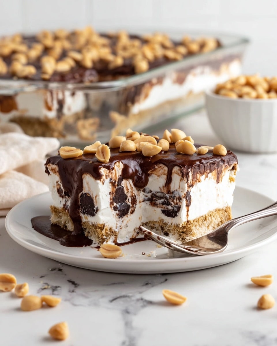The image shows a dessert slice on a white plate with a white marbled surface. The dessert has five visible layers: the bottom layer is light brown and crumbly with bits of darker pieces mixed in; above that is a thick creamy white layer; followed by a dark brown, rich-looking chocolate layer; then a thick white fluffy layer with small brown swirls; and on top is a thick, textured dark chocolate layer with pieces of chopped light brown nuts sprinkled over it. The background shows more of the dessert in a clear container. Photo taken with an iphone --ar 4:5 --v 7