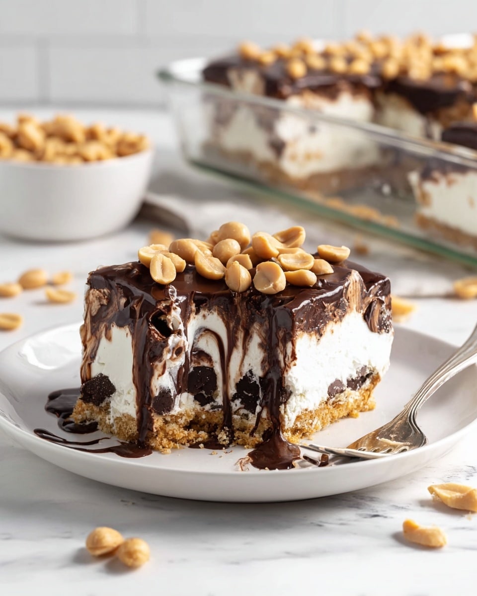 The image shows a layered dessert square on a white plate with a white marbled surface underneath. The bottom layer is a light brown crumbly crust, followed by a thick white creamy layer with dark chocolate pieces swirled inside. Above that is a smooth, thick dark chocolate layer topped with whole peanuts scattered across the top. A piece has been taken from the square, revealing the creamy and chocolate swirled inside, with some chocolate dripping down the side. A fork with a bite of the dessert rests on the plate beside it, and some peanuts are scattered around. In the background, there is a square glass dish filled with the same dessert and a small white bowl full of peanuts. Photo taken with an iphone --ar 4:5 --v 7