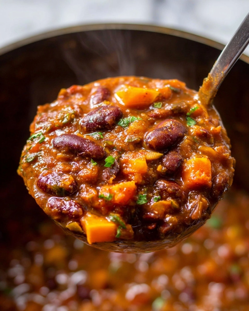 A close-up of a ladle full of thick chili stew held above a pot. The stew has three main layers: dark red kidney beans scattered throughout, orange chunks of vegetables like carrots and squash mixed in a reddish-brown rich sauce, and small green herb pieces sprinkled on top. The ladle shows a glossy, hearty texture with visible steam rising, and the pot below is filled with more of the same chunky stew. The background has a white marbled texture. photo taken with an iphone --ar 4:5 --v 7