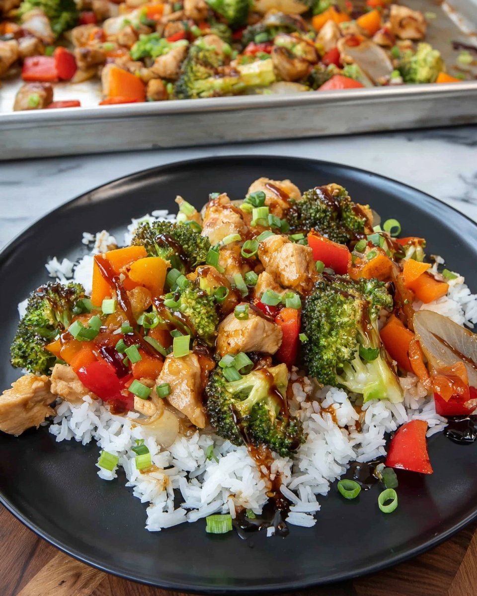The image shows a metal baking tray filled with a colorful stir-fry dish made of several layers. The bottom layer is a mix of small broccoli florets and diced chicken pieces cooked to a light brown color. On top of this are chunks of roasted yellow and orange bell peppers, pieces of white onion, and more larger broccoli pieces with some parts slightly charred. Scattered throughout are bright red bell pepper chunks. The dish is drizzled with a shiny dark sauce that adds a glossy texture, and chopped green onions are sprinkled over everything, adding a fresh green touch. A metal spoon is partially visible in the upper right corner, resting on the food. The background is a white marbled surface. photo taken with an iphone --ar 4:5 --v 7