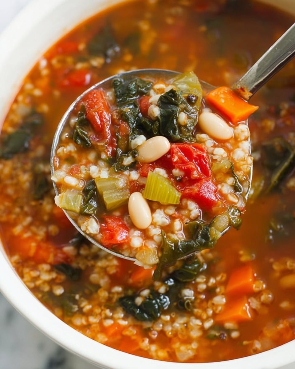 A close-up view of a thick vegetable and bean soup in a white bowl shows multiple layers and colors. The base layer is a rich, orange-red broth filled with small grains. Floating on top are pieces of white beans, chopped green leafy vegetables, bright orange carrot cubes, green celery slices, and red tomato chunks. A metal ladle lifts some soup, displaying the mix of colors and textures in one scoop. The background is a white marbled texture. photo taken with an iphone --ar 4:5 --v 7