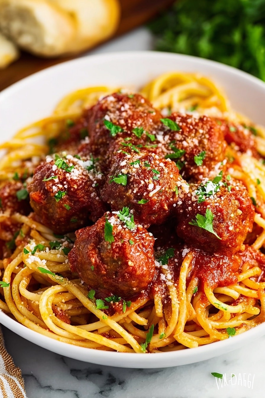 A white shallow bowl filled with a nest of thick yellow spaghetti noodles, topped with seven round brown meatballs coated in red tomato sauce. The tomato sauce covers some parts of the noodles lightly, with a sprinkle of white grated cheese and small bright green parsley leaves scattered on top. The bowl is placed on a white marbled surface with some blurred green herbs and a piece of bread in the background. photo taken with an iphone --ar 2:3 --v 7 - Easy Crock Pot Spaghetti with Meatballs, slow cooker spaghetti and meatballs, simple crockpot pasta dish, effortless comfort food, one-pot spaghetti recipe
