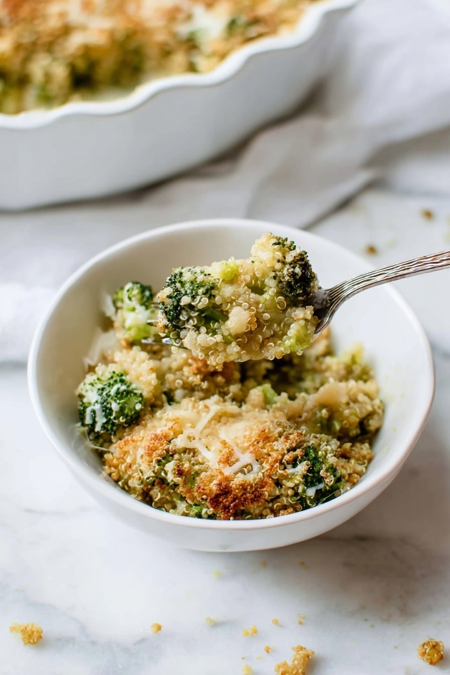 A close-up view shows a white bowl with a textured rim filled with a broccoli quinoa casserole. The dish has several layers visible: bright green broccoli pieces mixed with light tan quinoa, topped with a crumbly golden-brown crust sprinkled with some melted white cheese strands. The casserole looks baked, with some crispy bits giving it a crunchy texture. A silver fork stands inside the bowl on the right side, partially covered in the casserole. The bowl sits on a soft white cloth over a white marbled surface. Photo taken with an iphone --ar 2:3 --v 7 - Better Broccoli Casserole, healthy broccoli casserole, cheesy quinoa broccoli bake, roasted broccoli side dish, easy veggie casserole