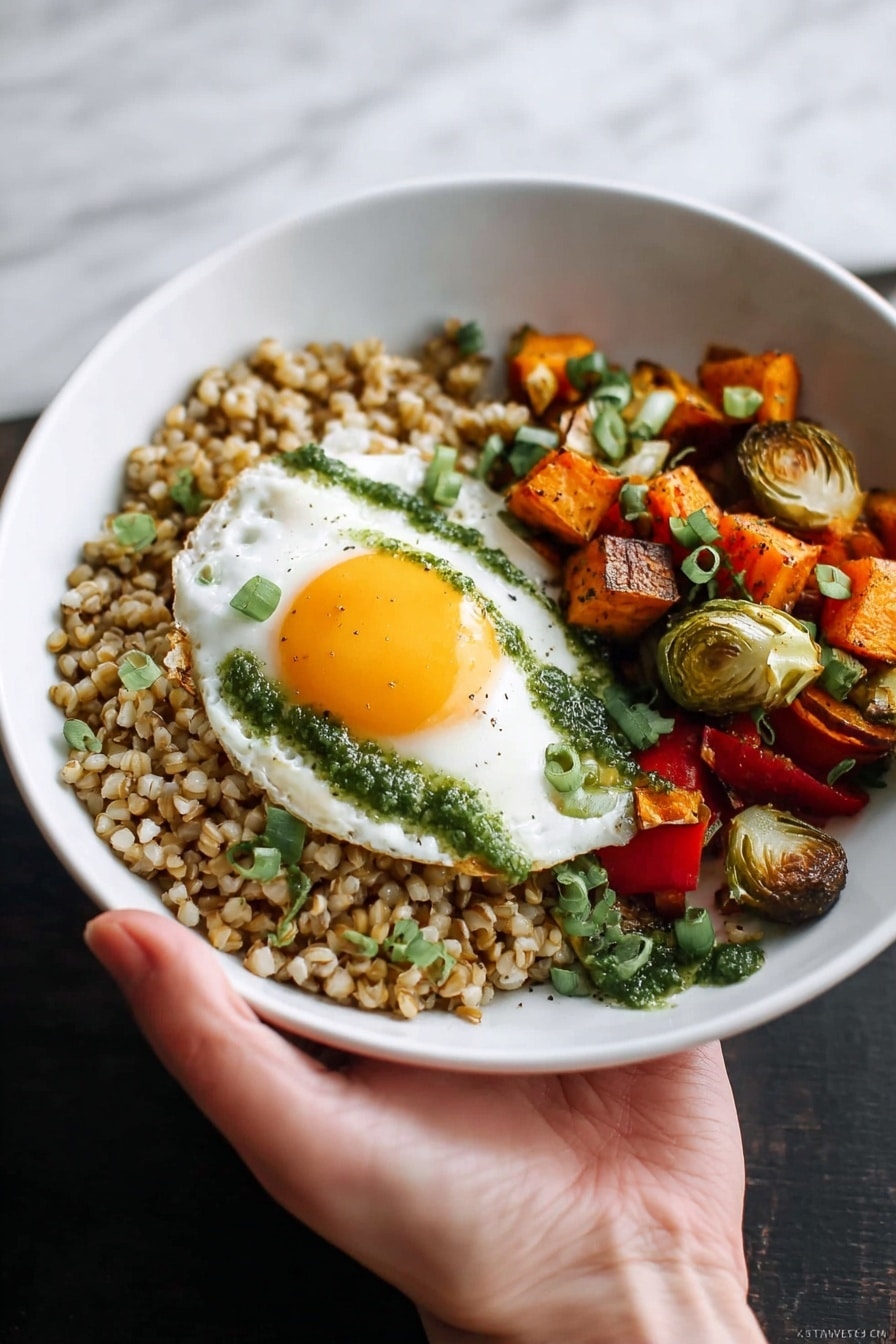 A white bowl is filled with three main layers: on the left, a bed of cooked brown grains with a slightly moist texture, topped with small green herb pieces; next to it, a colorful mix of roasted vegetables including red bell peppers, Brussels sprouts halved and light green inside, orange sweet potato cubes, and chunks of red onion; on top of the vegetables rests a fried egg with a bright yellow runny yolk spilling onto the vegetables and grains, with green herb sauce drizzled on the egg white. A fork is pulling into the yolk from the bottom left of the bowl, held by a woman's hand. The bowl sits on a white marbled textured cloth background with a bit of wooden surface showing. Photo taken with an iphone --ar 2:3 --v 7 - Harvest Vegetable Grain Bowl with Egg, healthy grain bowls, fall vegetable recipes, nourishing breakfast ideas, autumn vegetable bowls