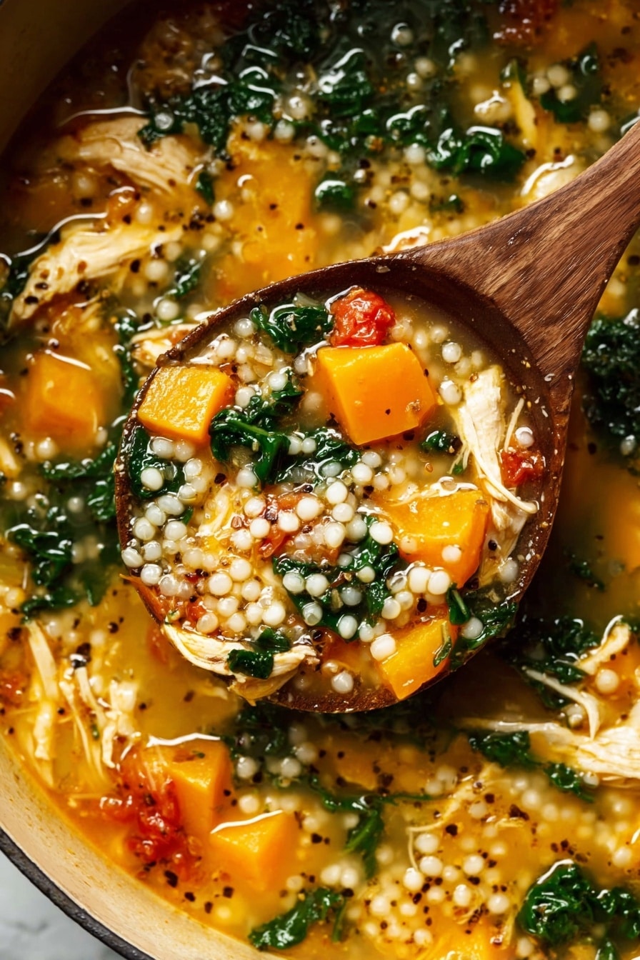 A wooden spoon lifts a thick soup filled with three main layers: plump white pearl-like grains scattered throughout, soft bright orange chunks of cooked squash, and wilted dark green leafy vegetables mixed in a light golden broth. The soup also contains pieces of shredded pale yellow chicken and small red tomato chunks, with black and white mustard seeds floating on top, all inside a pot sitting on a white marbled surface. The texture looks rich and hearty with a mix of soft and tender ingredients. Photo taken with an iphone --ar 2:3 --v 7 - Fall Chicken Stew with Quinoa and Butternut Squash, hearty fall chicken stew, healthy chicken and butternut squash stew, comforting quinoa chicken dinner, easy autumn chicken recipe