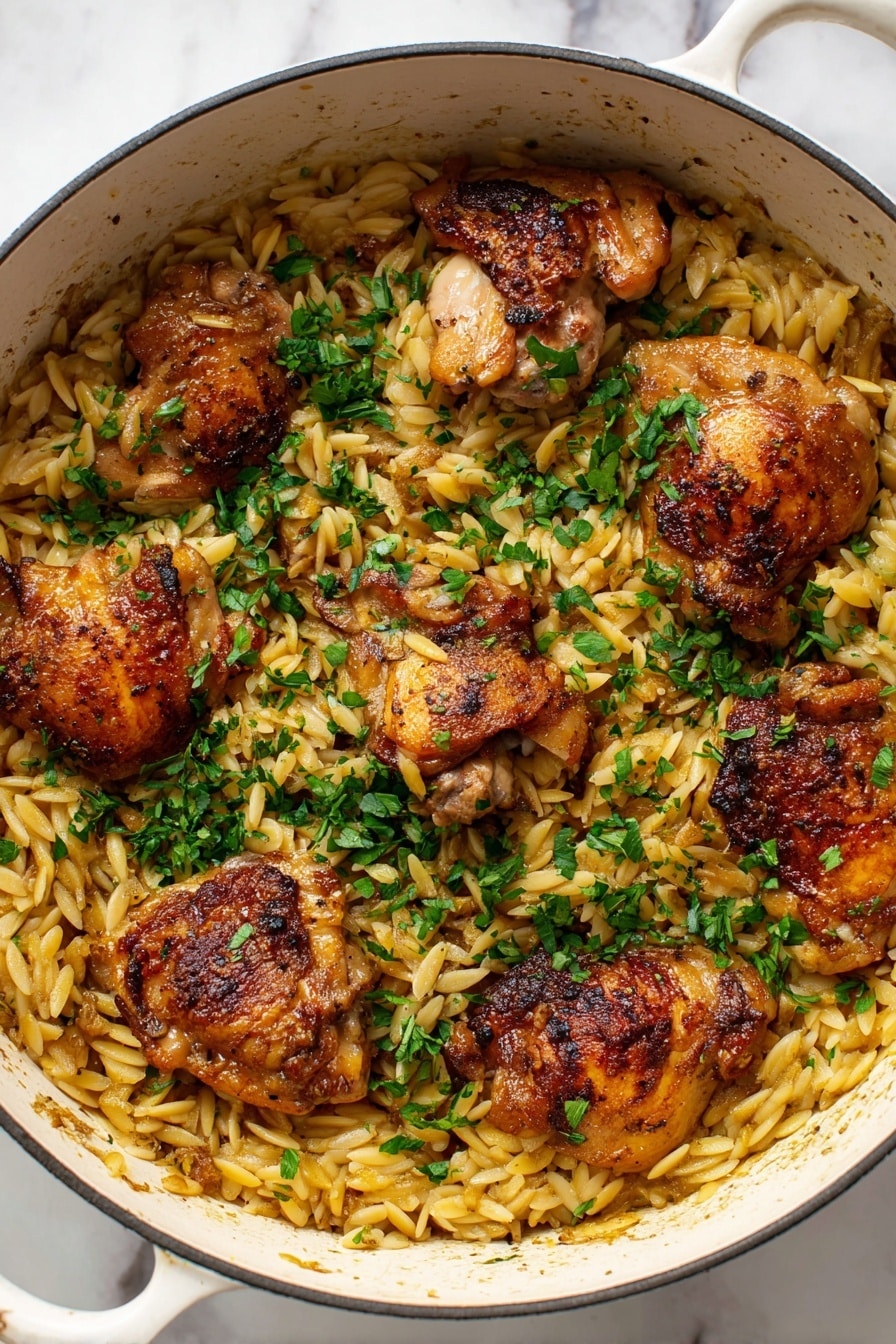 A white pot filled with light golden orzo pasta as the base layer, topped with five crispy browned chicken thighs spread evenly across the pasta. The chicken has a slightly shiny texture from cooking, with a mix of golden and darker brown spots. Bright green chopped herbs are sprinkled generously on top, adding a fresh contrast to the warm tones of the chicken and pasta. The pot sits on a white marbled surface. Photo taken with an iphone --ar 2:3 --v 7 - One Pot Garlic Butter Chicken and Orzo, garlic butter chicken skillet, easy one pot chicken and orzo, comforting chicken dinner, quick weeknight chicken