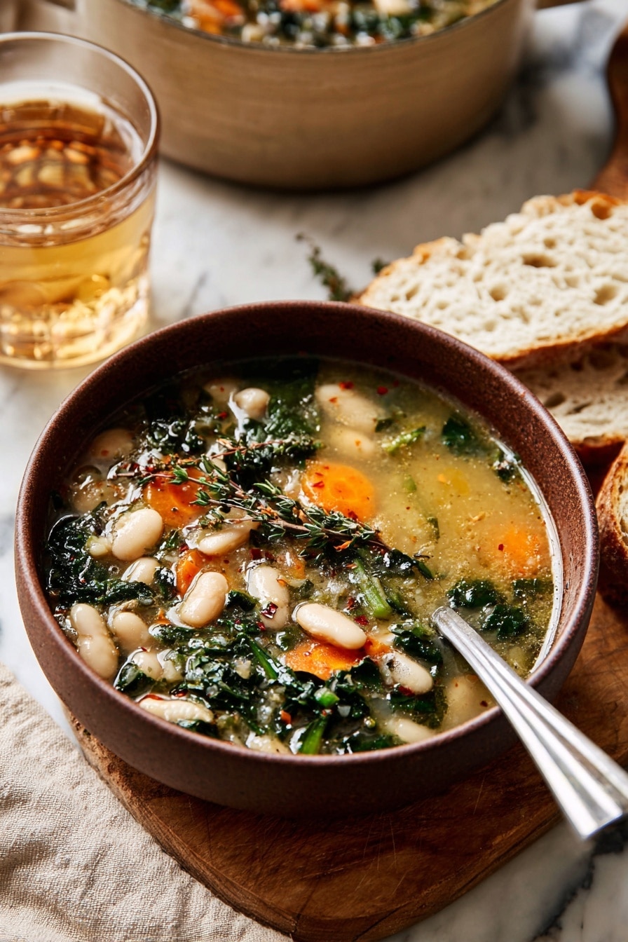 A bowl of soup with light golden broth fills the bowl, showing two layers of ingredients: the first layer has white beans and bright orange carrot slices, while the second layer includes dark green leafy herbs and some small herbs sprinkled on top. The bowl is brown and sits on a wooden board with pieces of white bread beside it. A shiny silver spoon rests inside the bowl. Behind the bowl, a clear glass of light brown drink and a large beige pot can be seen, all placed on a white marbled surface with a beige cloth underneath. Photo taken with an iphone --ar 2:3 --v 7 - Tuscan White Bean Soup, Italian White Bean Soup, hearty bean soup recipe, healthy vegetable soup, comforting Tuscan soup