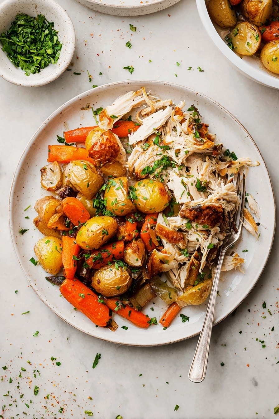 The dish shows a white round plate filled with two main layers: on the left side, there is shredded white meat with golden-brown skin pieces scattered on top, adding texture and color contrast; on the right side, there is a mix of roasted vegetables including small golden-brown potatoes, bright orange carrot pieces, and browned onions, all lightly charred and scattered with chopped green herbs for freshness. A silver fork rests partly on the plate’s edge, pointing inward. Above and behind the plate, a small white bowl with chopped green herbs is visible, placed on a white marbled surface scattered with a few herbs and seasoning bits. Photo taken with an iphone --ar 2:3 --v 7 - Slow Roasted Herb-Infused Whole Chicken, herb roasted chicken, easy baked whole chicken, tender roast chicken, flavorful chicken recipe