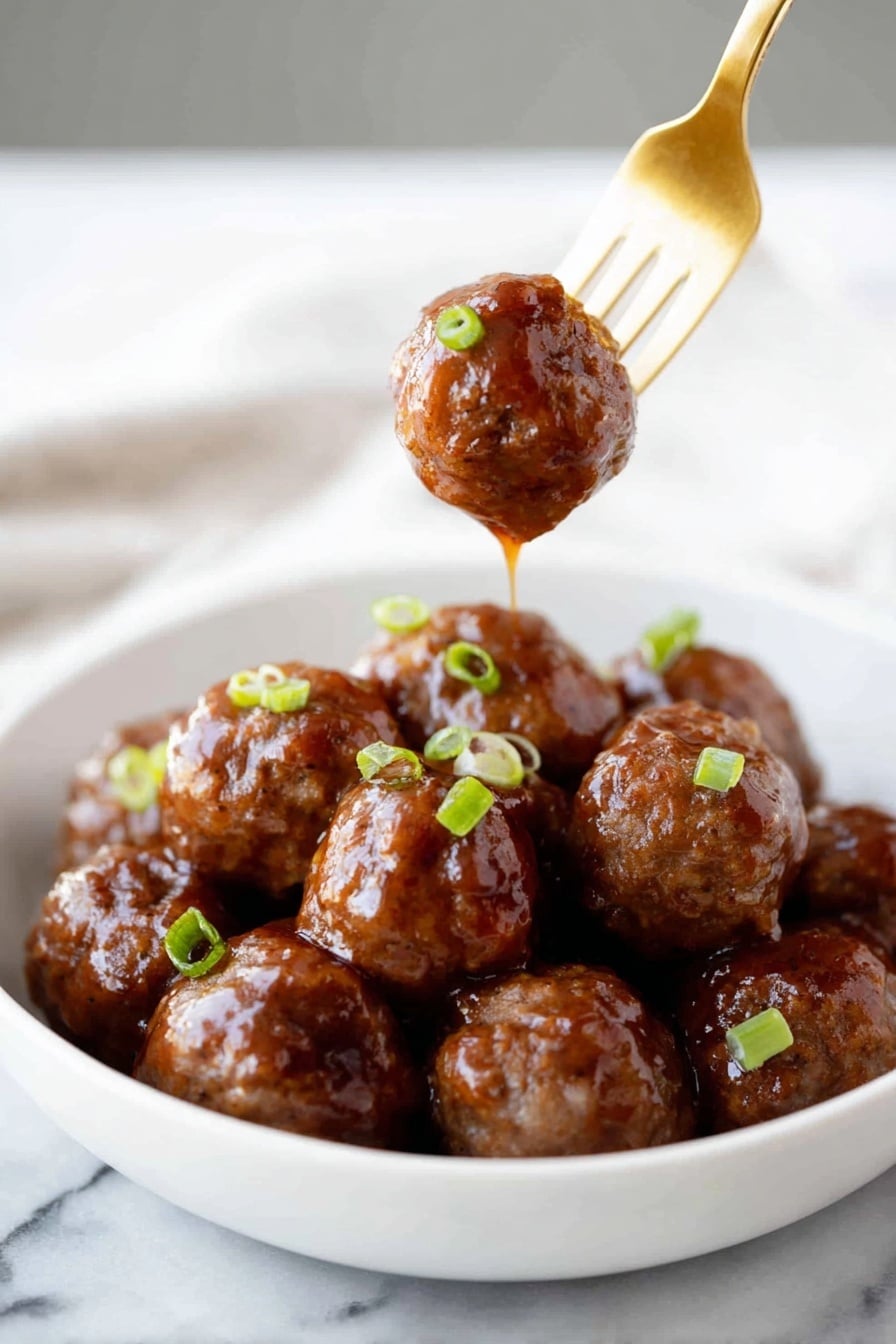 A white bowl filled with about a dozen shiny, brown meatballs covered in a thick, glossy sauce. The meatballs have a smooth, sticky texture and are garnished with small pieces of green onion scattered on top. One meatball is held above the bowl by a gold fork, with sauce dripping down from it. The scene is set on a white marbled surface. Photo taken with an iphone --ar 2:3 --v 7 - Sticky Honey Garlic Meatballs, Honey Garlic Meatballs, Easy Meatball Recipes, Delicious Dinner Ideas, Simple Meatball Dinner