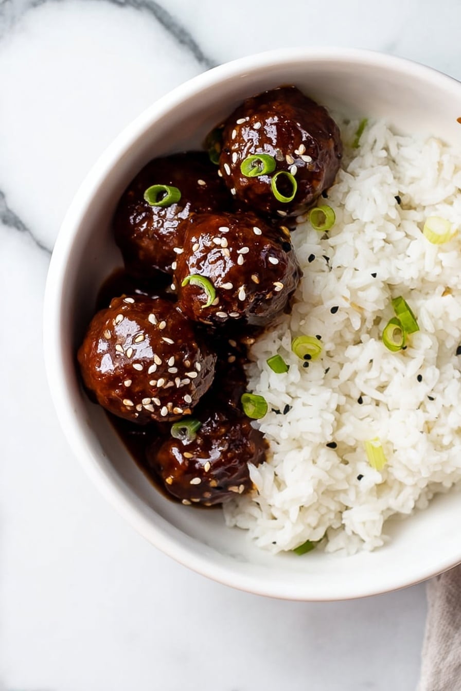 A white bowl sits on a white marbled surface, filled halfway with soft, fluffy white rice that has a few small green onion slices scattered on top. On one side of the bowl, four shiny, dark brown meatballs covered in a thick, glossy sauce are neatly placed. The meatballs are also sprinkled with sesame seeds and small pieces of green onion, adding contrast to their smooth, rich texture. photo taken with an iphone --ar 2:3 --v 7 - Sticky Honey Garlic Meatballs, Honey Garlic Meatballs, Easy Meatball Recipes, Delicious Dinner Ideas, Simple Meatball Dinner