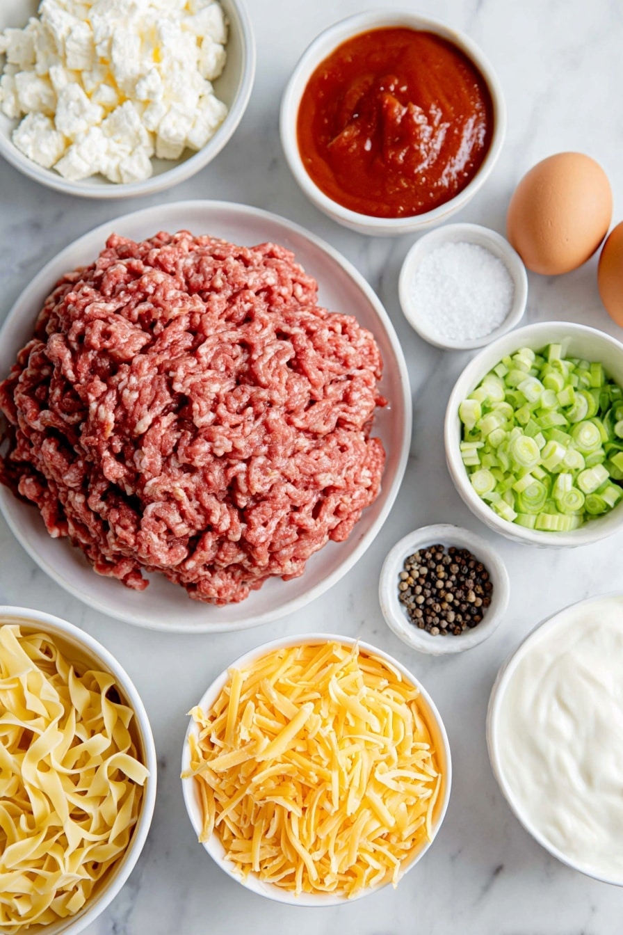 Flat lay of fresh raw ground chuck shaped in a loose mound, a small white ceramic bowl of smooth red tomato sauce, a small white ceramic bowl of thick white sour cream, a small white ceramic bowl filled with small curd cottage cheese, a neat pile of uncooked golden egg noodles, a handful of vibrant green sliced green onions arranged in a small white ceramic bowl, a small white ceramic bowl heaped with shredded sharp cheddar cheese, two whole brown eggs with clean shells, a small white ceramic bowl of coarse black peppercorns, a small white ceramic bowl of white salt crystals, all placed with perfect symmetry on a clean white marble surface, soft natural light, photo taken with an iPhone, professional food photography style, fresh ingredients, white ceramic bowls, no bottles, no duplicates, no utensils, no packaging --ar 2:3 --v 7 --p m7354615311229779997 - Sour Cream Noodle Bake with Ground Beef, hearty ground beef casserole, creamy beef noodle bake, easy comfort food recipes, family-friendly dinner ideas