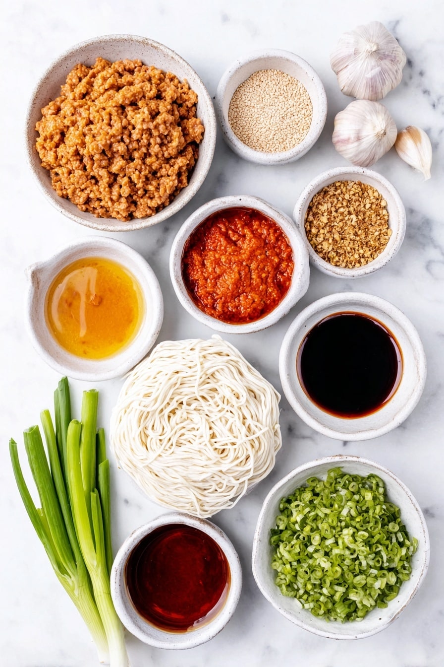 Flat lay of a small white ceramic bowl of creamy Chinese sesame paste, a small white bowl of vibrant red Chinese chili paste in oil, a small white bowl of dark light soy sauce, two whole uncracked garlic cloves, a small white bowl of fine white sugar, a small white bowl of Chinese five spice powder, a small white bowl of ground Sichuan pepper powder, a small white bowl of bright red chili oil, a small white bowl of golden chicken broth, a small white bowl of glossy dark hoisin sauce, a small white bowl of dark soy sauce, a small white bowl of clear Chinese cooking wine, a small white bowl of vegetable oil, a neat pile of fresh pale pink ground pork mince, a small white bowl of finely chopped preserved mustard greens, a nest of fresh white medium-thickness noodles, several fresh green choy sum stems cut into 15cm pieces, two whole green onions finely sliced, and a small white bowl of finely chopped peanuts, all arranged symmetrically on a clean white marble surface, soft natural light, photo taken with an iPhone, professional food photography style, fresh ingredients, white ceramic bowls, no bottles, no duplicates, no utensils, no packaging --ar 2:3 --v 7 --p m7354615311229779997 - Spicy Dan Dan Noodles with Pork, Dan Dan Noodles, Chinese spicy noodles, Pork noodle stir-fry, Easy Sichuan noodle recipe