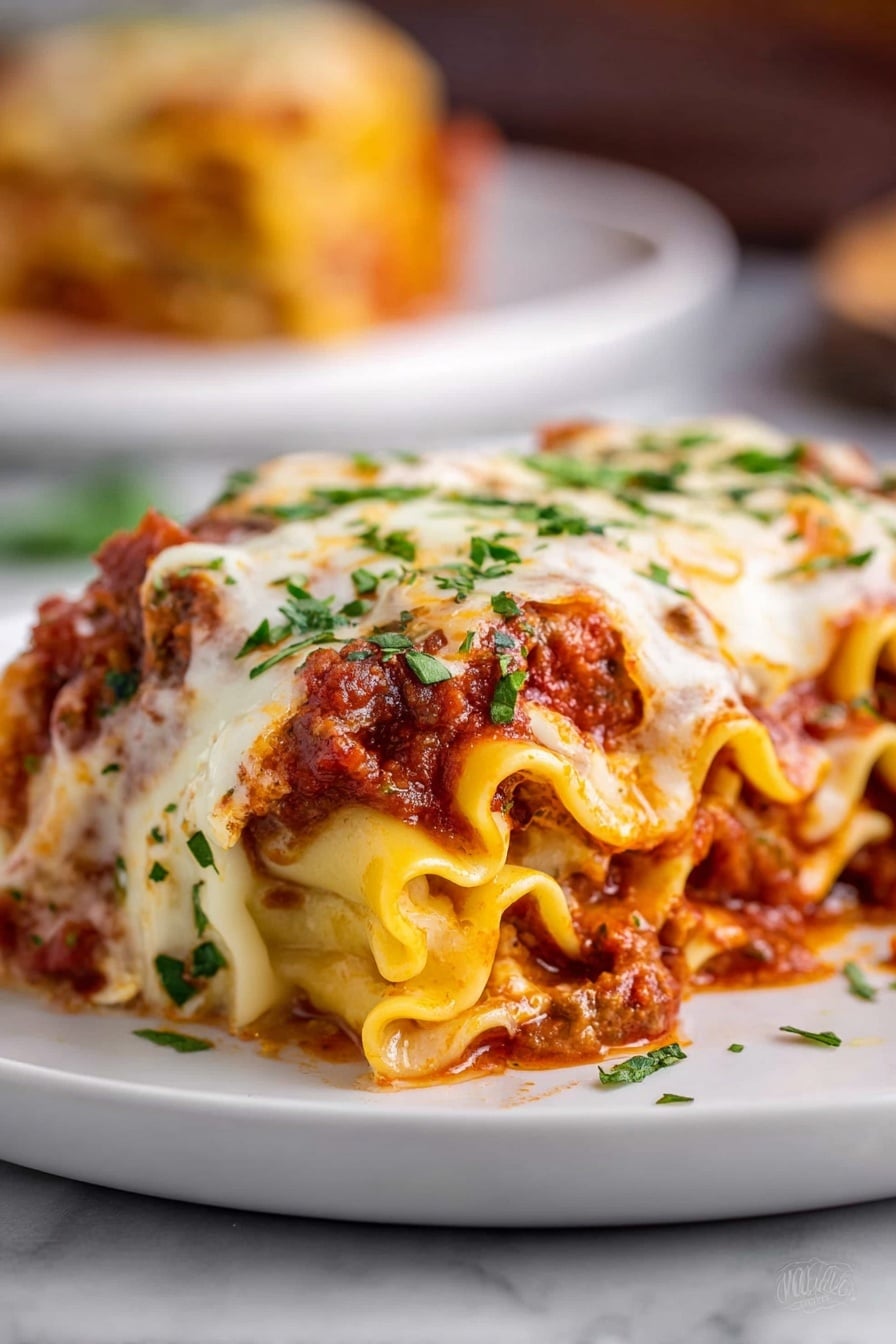 The image shows a close-up of a rolled lasagna piece on a white plate, placed over a white marbled surface. The lasagna has many wavy layers of soft, yellow pasta filled with a thick red meat sauce and melted cheese. The top is covered with a layer of creamy white melted cheese that is slightly browned in spots, sprinkled with bright green chopped herbs. The sauce peeks through the edges of the pasta rolls, adding a rich red color to the dish. In the blurred background, part of another portion is visible on a similar white plate. Photo taken with an iphone --ar 2:3 --v 7 - Cheesy Beef Lasagna Roll-Ups, Beef Lasagna Roll-Ups, Easy Lasagna Roll-Ups, Italian Beef Roll-Ups, Comfort Food Dinner