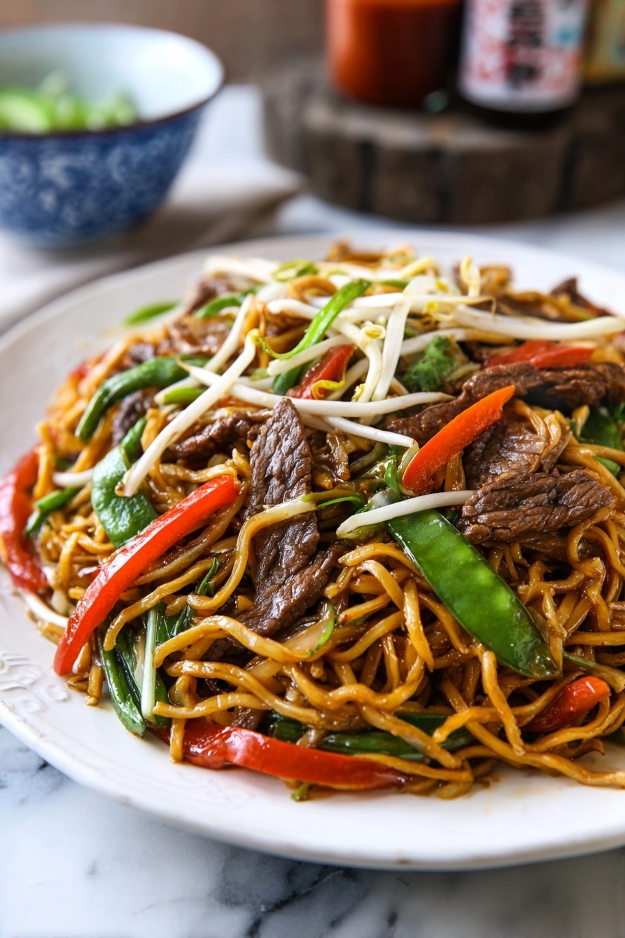 A white oval plate is filled with stir-fried noodles that are light brown and glossy, mixed with slices of dark brown beef, bright green snow peas, thin red chili strips, white bean sprouts, and pieces of translucent onion. The noodles are twisted and piled up high on the plate, with colorful vegetables and beef evenly spread throughout. The plate sits on a rustic wooden surface, with a blue cloth partially visible under one side. In the background, there are two brown bottles with red labels and a white bowl with blue patterns. photo taken with an iphone --ar 2:3 --v 7 - Beef Lo Mein Stir-Fry, beef lo mein recipe, easy beef lo mein, quick stir-fry noodle dish, homemade lo mein with beef