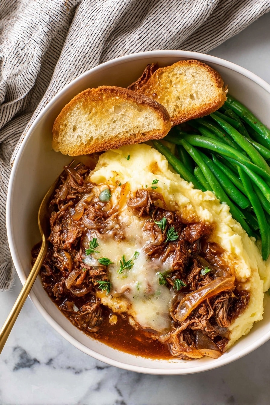 In a white bowl placed on a white marbled surface, there is a dish made of several layers: the bottom left layer is smooth, pale yellow mashed potatoes, topped with a thick layer of rich brown meat with melted white cheese and cooked onions covering the center. To the right, there are bright green cooked green beans stacked neatly. At the top left, two slices of toasted bread rest on the mashed potatoes, all under warm natural light. A golden fork is partly inserted into the mashed potatoes near the meat. A soft, striped towel is seen in the top left corner. Photo taken with an iphone --ar 2:3 --v 7 - French Onion Chuck Roast, caramelized onion beef roast, slow-cooker roast with Gruyere, tender beef dinner recipes, comforting beef casserole