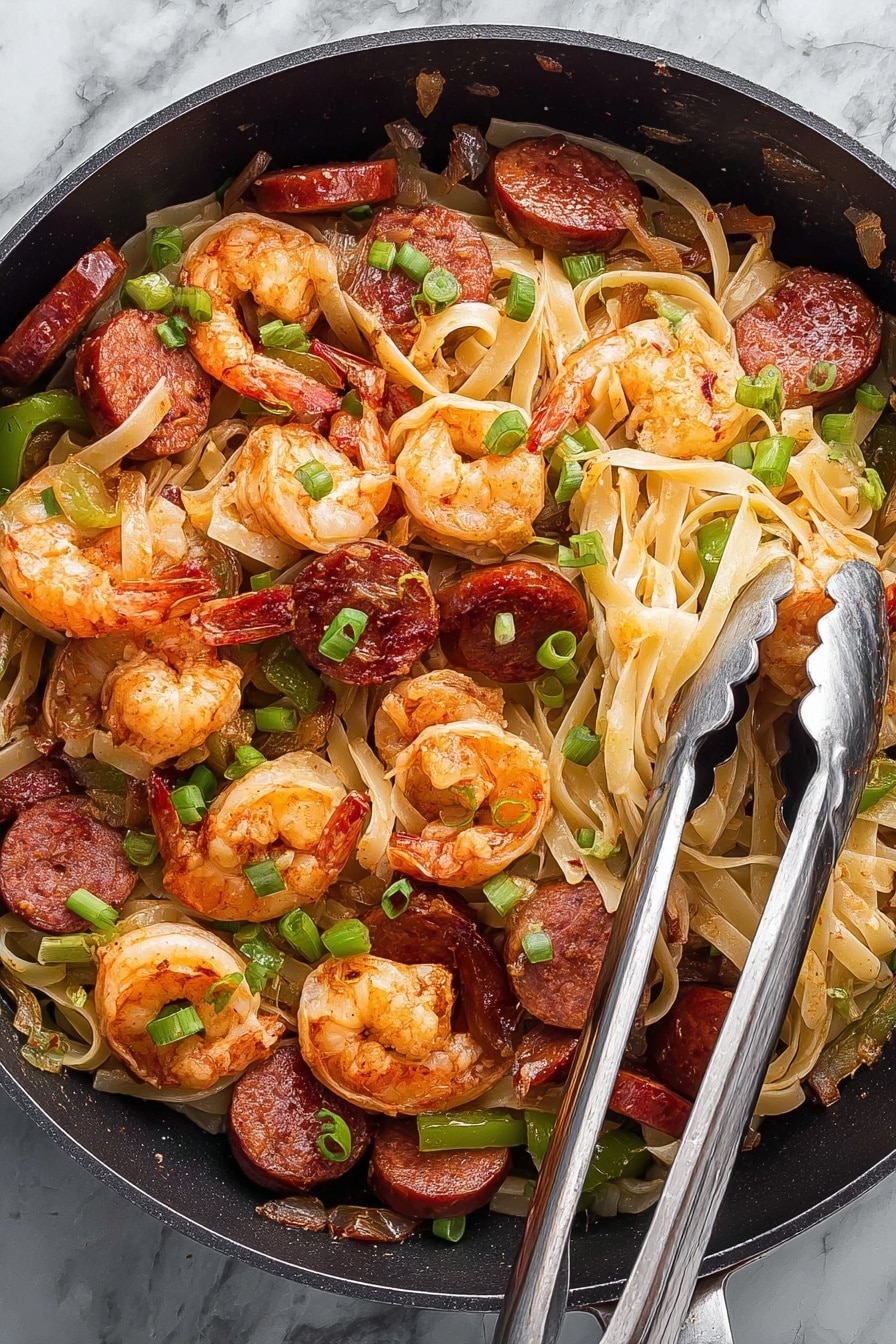 A close-up of a black plate filled with thick, creamy light yellow noodles forming the main layer. On top, there are two bright orange cooked shrimp with curled tails, slightly shiny and seasoned. Scattered among the noodles are green onion pieces with fresh, glossy leaves, and slices of reddish-brown sausage with a slightly shiny surface. A silver fork rests on the right side of the plate. The plate sits on a white marbled texture surface. Photo taken with an iphone --ar 2:3 --v 7 - Cajun Shrimp and Sausage Pasta, Cajun pasta recipes, spicy shrimp pasta, Cajun sausage pasta, easy Cajun dinner ideas