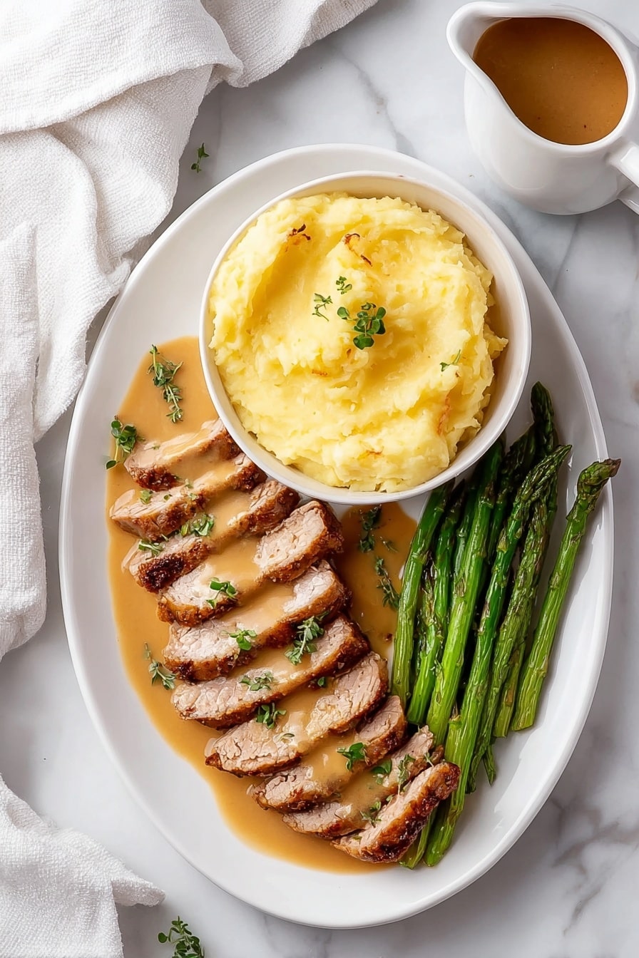 The image shows a white oval plate with three layers of food arranged neatly. On the top right, there is a white bowl filled with smooth, light yellow mashed potatoes, sitting on the plate. Below the bowl, two rows of sliced, cooked meat lay side by side, coated with a light brown sauce and garnished with small green herb leaves. On the bottom right corner of the plate, a bunch of green asparagus spears is placed parallel to the meat. The plate rests on a white marbled surface, and a white cloth is partially visible on the left side. There is also a small pitcher with brown sauce near the top right corner. Photo taken with an iphone --ar 2:3 --v 7 - Garlic Turkey Tenderloin with Easy Gravy, Turkey Tenderloin recipe, quick turkey dinner, flavorful turkey entrees, easy turkey recipes for weeknights