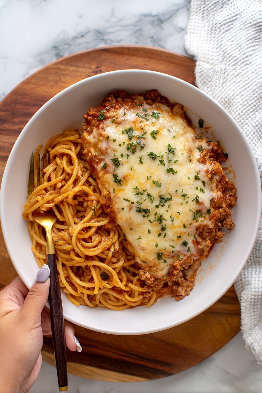 A white rectangular baking dish filled with a layered lasagna, showing golden-brown melted cheese on top with some darker browned spots and red tomato sauce peeking through. The edges are bubbly and slightly crispy, showing a textured mix of cheese and sauce. Around the dish, there is a beige cloth beneath, and on the white marbled surface near the top-left corner, there are two small white bowls, one filled with fresh green parsley and the other with thin white slices, possibly cheese. photo taken with an iphone --ar 2:3 --v 7 - Baked Sausage Spaghetti Casserole, cheesy sausage pasta bake, easy sausage spaghetti dinner, hearty sausage casserole, quick baked pasta dish