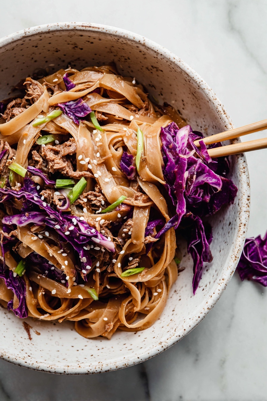 The image shows a white speckled bowl filled with a noodle dish. The bottom layer is made of wide, flat, light brown noodles coated in sauce. Mixed in and on top are shredded pieces of brown cooked meat and thin strips of bright purple cabbage, adding color contrast. Scattered over the dish are small white sesame seeds and green sliced scallions for garnish. A pair of chopsticks rests inside the bowl on the right side, holding some purple cabbage and noodles. The bowl is placed on a surface with a white marbled texture, and a small piece of purple cabbage is nearby. photo taken with an iphone --ar 2:3 --v 7 - Thai Peanut Chicken Noodles, Thai peanut noodles, Chicken noodle stir-fry, Creamy peanut sauce recipes, Easy Asian chicken dishes