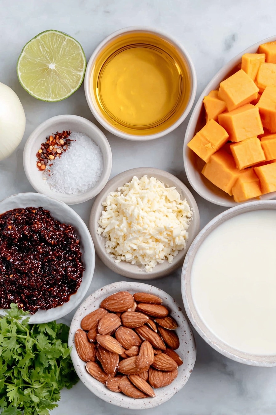 Flat lay of a small white ceramic bowl of golden oil, one whole white onion with smooth skin, a small mound of freshly minced ginger, vibrant orange cubed butternut squash, a small white ceramic bowl holding deep red curry paste, another small white bowl with creamy smooth almond butter, a simple white bowl filled with light-colored vegetable broth, a white ceramic bowl containing thick full fat coconut milk, half a fresh green lime cut open showing juicy segments, a small white bowl of coarse salt crystals, a tiny white bowl of ground black pepper, a small neat pile of roasted sliced almonds, a handful of bright green chopped cilantro, and a small white bowl holding red chili flakes, all arranged with perfect symmetry on a clean white marble surface, soft natural light, photo taken with an iPhone, professional food photography style, fresh ingredients, white ceramic bowls, no bottles, no duplicates, no utensils, no packaging --ar 2:3 --v 7 --p m7354615311229779997 - Instant Pot Thai Butternut Squash Soup, Thai butternut squash soup, quick healthy soup recipes, creamy coconut butternut squash soup, easy Thai curry soup