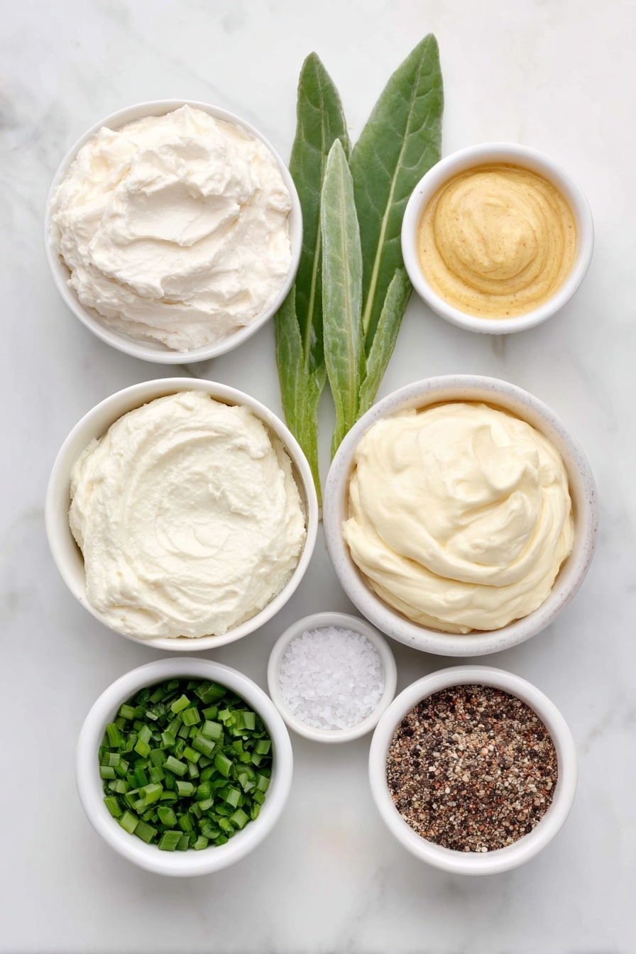 Flat lay of a small white ceramic bowl of creamy sour cream, a small white ceramic bowl with a dollop of prepared horseradish root next to a few fresh horseradish leaves, a small white ceramic bowl of smooth mayonnaise, a small white ceramic bowl containing bright green finely chopped chives, a small white ceramic bowl of golden Dijon mustard, a small white ceramic bowl with coarse kosher salt crystals, and a small white ceramic bowl with freshly ground black pepper, all arranged symmetrically and balanced, placed on a clean white marble surface, soft natural light, photo taken with an iPhone, professional food photography style, fresh ingredients, white ceramic bowls, no bottles, no duplicates, no utensils, no packaging --ar 2:3 --v 7 --p m7354615311229779997 - Creamy Horseradish Sauce for Prime Rib, horseradish sauce, prime rib condiment, easy beef sauce, flavorful meat dipping sauce