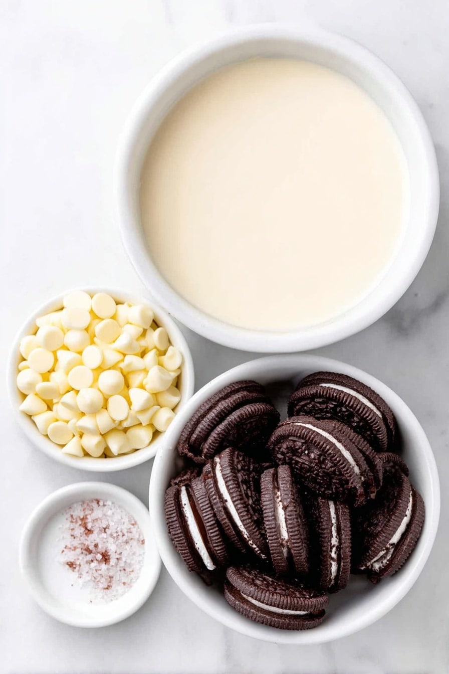 Flat lay of a small mound of glossy white chocolate chips, a simple white ceramic bowl filled with smooth, creamy condensed milk, a neat pile of crushed black-and-white Oreo cookie pieces showing the chocolate cookie and creamy filling contrast, and a tiny pinch of coarse white sea salt on a white ceramic spoon rest, all arranged in perfect symmetry placed on a clean white marble surface, soft natural light, photo taken with an iPhone, professional food photography style, fresh ingredients, white ceramic bowls, no bottles, no duplicates, no utensils, no packaging --ar 2:3 --v 7 --p m7354615311229779997 - White Chocolate Oreo Fudge, easy Oreo fudge recipe, no-bake Oreo dessert, quick white chocolate fudge, simple Oreo fudge