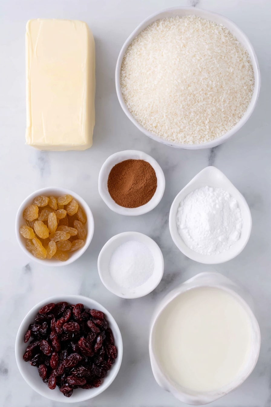 Flat lay of unsalted butter pat, a small white ceramic bowl of whole milk, a small white ceramic bowl of white sugar, a small white ceramic bowl of vanilla extract, a small white ceramic bowl of uncooked medium grain white rice, a small white ceramic bowl of golden sultanas, a small white ceramic bowl of ground cinnamon, a small white ceramic bowl of thickened cream, placed on a clean white marble surface, soft natural light, photo taken with an iPhone, professional food photography style, fresh ingredients, white ceramic bowls, no bottles, no duplicates, no utensils, no packaging --ar 2:3 --v 7 --p m7354615311229779997 - Creamy Cinnamon Rice Pudding, rice pudding with cinnamon, easy rice pudding recipe, cozy dessert with raisins, baked rice pudding