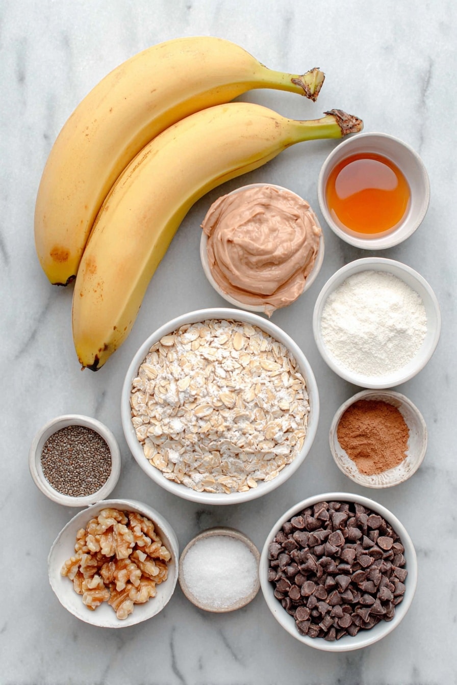 Flat lay of two large extra ripe bananas, a small white bowl of natural peanut butter, a small white bowl of pure maple syrup, one whole uncracked large egg with clean shell, a small white bowl of pure vanilla extract, a small white bowl of oat flour, a small white bowl of flaxseed meal, a small white bowl of ground cinnamon, a small white bowl of baking soda, a small white bowl of kosher salt, a small white bowl of old fashioned rolled oats, a small white bowl of hemp hearts, a small white bowl of chia seeds, a small white bowl of semi-sweet chocolate chips, a small white bowl of chopped walnuts, and a small white bowl with flaky sea salt, all arranged in perfect symmetry on a clean white marble surface, soft natural light, photo taken with an iPhone, professional food photography style, fresh ingredients, white ceramic bowls, no bottles, no duplicates, no utensils, no packaging --ar 2:3 --v 7 --p m7354615311229779997 - Healthy Banana Breakfast Cookies, healthy breakfast cookies, nutritious banana cookies, easy healthy cookie recipes, wholesome breakfast snacks