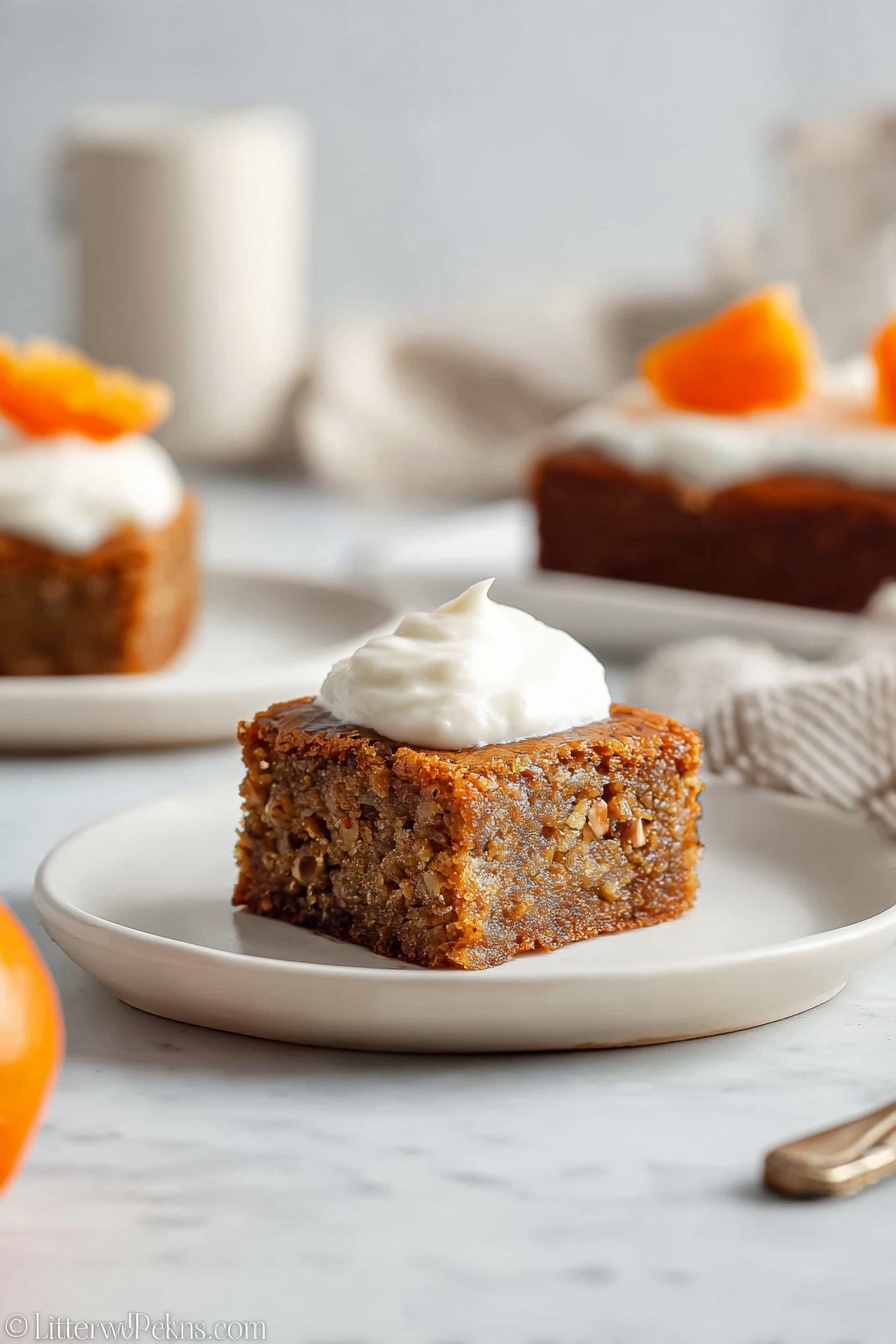 A square piece of brown cake with small nut bits visible inside is placed on a white plate. On top of the cake, there is a dollop of smooth white cream. The texture of the cake looks moist and soft, and the edges are slightly darker, indicating it is well baked. In the background, there is another piece of the same cake with cream and a small orange slice on top, also on a white plate. The setting is on a white marbled surface with soft natural light, creating a clean and cozy atmosphere. Photo taken with an iphone --ar 2:3 --v 7 - Persimmon Pudding Cake with Nuts, persimmon dessert recipes, festive persimmon cake, moist persimmon cake with nuts, easy persimmon cake dessert