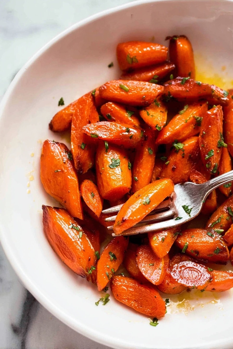 The image shows a white plate with a pile of roasted carrot pieces that are cut into small segments of different shapes, mostly oblong and triangular. The carrots are shiny with a glaze making them look moist and caramelized, with some darker browned spots on the edges indicating roasting. Small bits of green herbs are scattered over the carrots, adding a fresh contrast to the bright orange color. On the right side of the plate, a silver fork holds a piece of carrot above the surface. The background is a white marbled texture. photo taken with an iphone --ar 2:3 --v 7 - Brown Sugar Roasted Carrots, caramelized carrot side dish, easy roasted vegetable recipe, sweet roasted carrots, healthy vegetable side