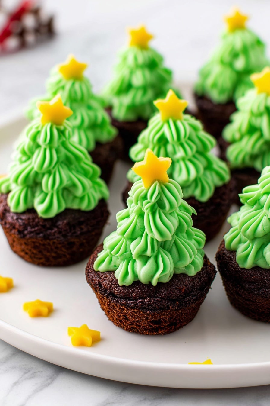 The image shows several small cupcakes arranged on a white round plate with a white marbled surface underneath. Each cupcake has two layers: the bottom layer is a dark brown chocolate base with a rough texture, and the top layer is bright green frosting piped in a swirl, shaped like a Christmas tree. Each frosting top is decorated with a small yellow star on the very tip. Tiny yellow star-shaped sprinkles are also scattered on the plate and the marbled surface around the plate. Photo taken with an iphone --ar 2:3 --v 7 - Holiday Green Frosted Brownie Bites, festive brownie treats, Christmas brownie bites, green frosting brownie ideas, holiday party dessert recipes