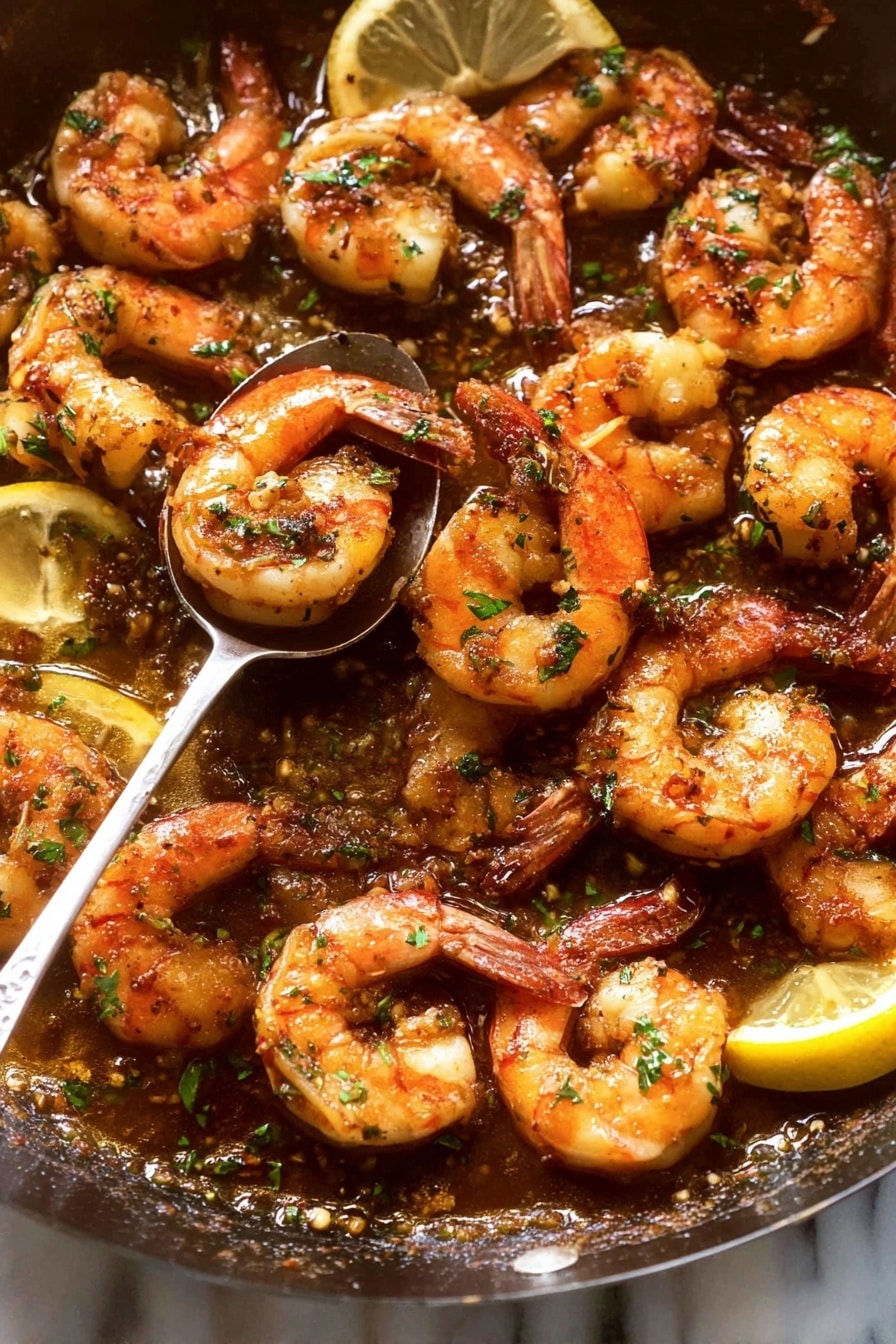 The image shows a close-up view of cooked shrimp piled on a white plate. The shrimp are orange with charred marks and sprinkled with small green herb flakes. A spoon is held above the shrimp by a woman's hand, dripping a golden sauce onto them. The background surface is a white marbled texture. photo taken with an iphone --ar 2:3 --v 7 - Garlic Shrimp Skillet, garlic shrimp recipe, quick seafood dinner, easy shrimp skillet, flavorful garlic shrimp