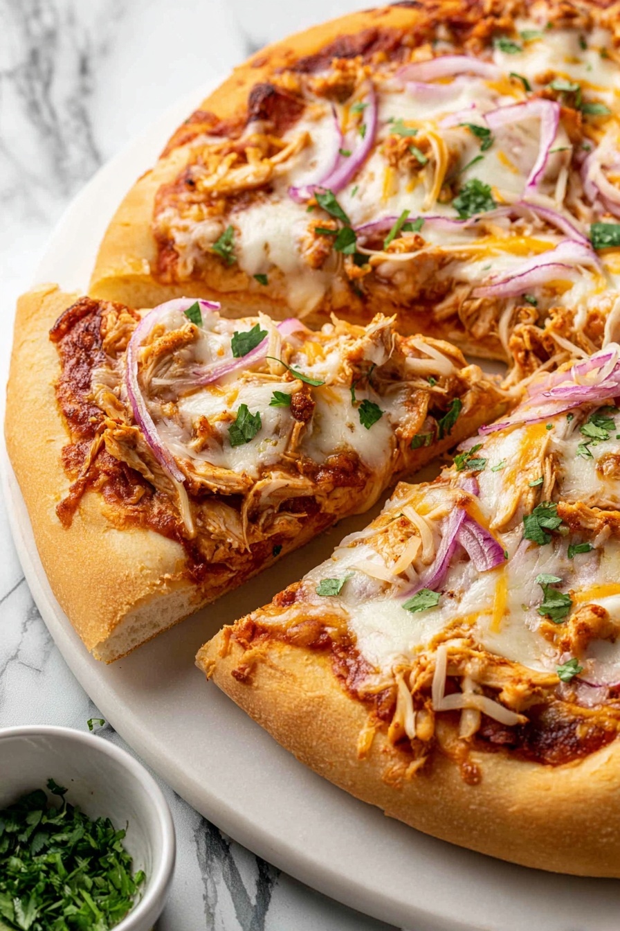 A close-up view of a pizza with a thick, golden brown crust. It has one base layer of reddish tomato sauce spread evenly, topped with a melted white cheese layer that looks soft and stretchy. On top, there are thin slices of purple onion, small pieces of light brown chicken, shredded yellow cheese, and scattered green herb bits. One slice is slightly pulled away from the rest, showing the fluffy inside of the crust. The pizza sits on a white plate placed on a white marbled surface, with a small bowl of green herbs nearby. photo taken with an iphone --ar 2:3 --v 7 - BBQ Chicken Pizza, BBQ Chicken Pizza Recipe, BBQ Chicken Pizza Toppings, How to Make BBQ Chicken Pizza, Easy BBQ Chicken Pizza