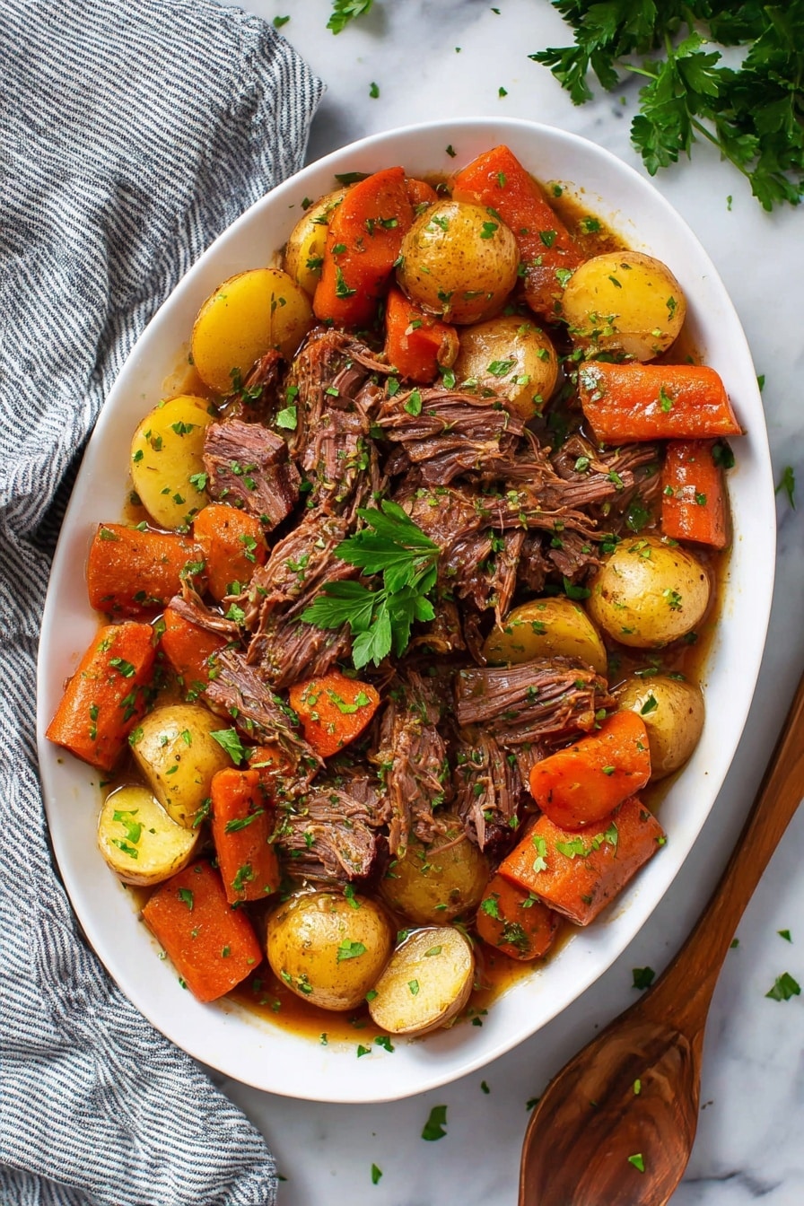 The dish is served in a white oval plate filled with layers of food. The bottom layer mainly consists of golden-yellow potato halves scattered evenly around the plate’s edge, with chunky orange carrot pieces mixed in between them. On top, pulled pieces of dark brown cooked meat are placed in the center and spread slightly toward the edges, blending with the veggies. The whole dish is sprinkled with fresh green parsley bits, adding a touch of brightness. The plate is on a white marble surface with a gray striped cloth partly visible on the left and some fresh parsley on the upper right. Photo taken with an iphone --ar 2:3 --v 7 - Slow Cooker Pot Roast, best pot roast recipe, easy beef roast, tender slow cooker beef, comforting dinner idea
