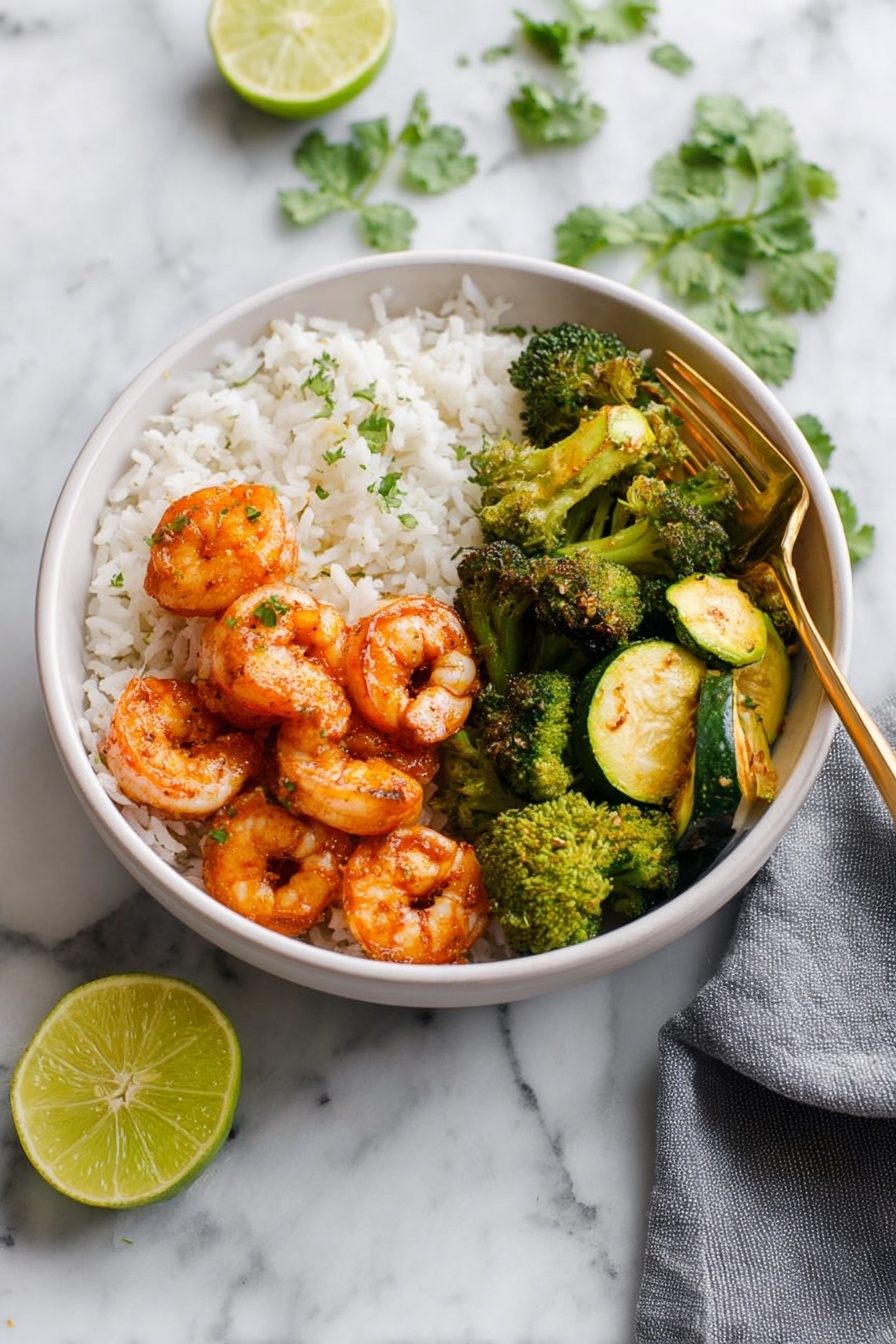 A white bowl on a white marbled surface holds a meal with three main layers: at the bottom is a base of plain white rice, topped on one side with vibrant orange cooked shrimp with a slight glaze, arranged in a small cluster. On another side of the bowl there are bright green cooked broccoli florets with a slightly roasted texture. The last section contains green and yellow cooked zucchini slices, showing a soft texture with slight grill marks. A gold fork rests inside the bowl on the right side, and fresh cilantro leaves are scattered in the background. A gray napkin is placed to the right of the bowl, and a halved lime sits on the surface near the bottom left corner. Photo taken with an iphone --ar 2:3 --v 7 - Spicy Shrimp Buddha Bowl, healthy shrimp Buddha bowl, quick shrimp Buddha bowl, flavorful Buddha bowl with shrimp, easy spicy shrimp meal