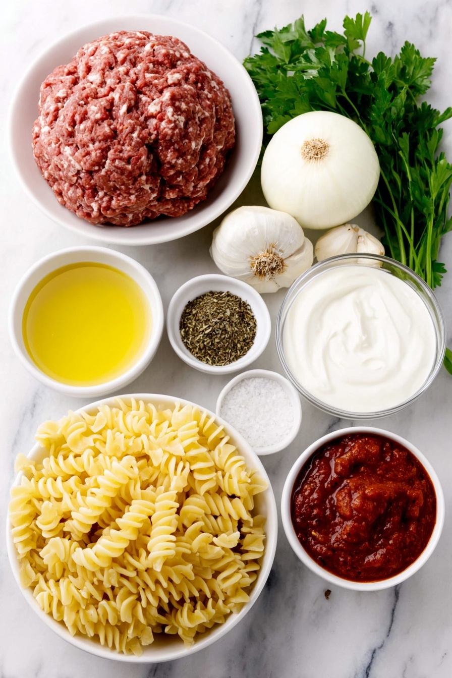 Flat lay of a small pool of golden olive oil in a simple white ceramic bowl, two whole uncracked brown garlic cloves, a peeled white onion cut in half showing its layers, a mound of fresh raw ground beef, a small white bowl filled with mixed Italian dried herbs, a small white bowl with deep red tomato paste, a small white bowl with crushed ripe red tomatoes, a few bright red chili flakes scattered beside a small white bowl of kosher salt crystals, a small white bowl of whole black peppercorns, a small white bowl filled with clear chicken stock, a neat pile of uncooked fusilli pasta, a small white bowl holding thick heavy cream, a small white ceramic bowl filled with finely grated pale yellow Parmesan cheese, a few sprigs of fresh bright green parsley placed gracefully, all placed on a clean white marble surface, soft natural light, photo taken with an iPhone, professional food photography style, fresh ingredients, white ceramic bowls, no bottles, no duplicates, no utensils, no packaging --ar 2:3 --v 7 --p m7354615311229779997 - Creamy Tomato Beef Pasta, creamy tomato beef pasta, beef pasta recipe, one-pot beef pasta, easy beef pasta