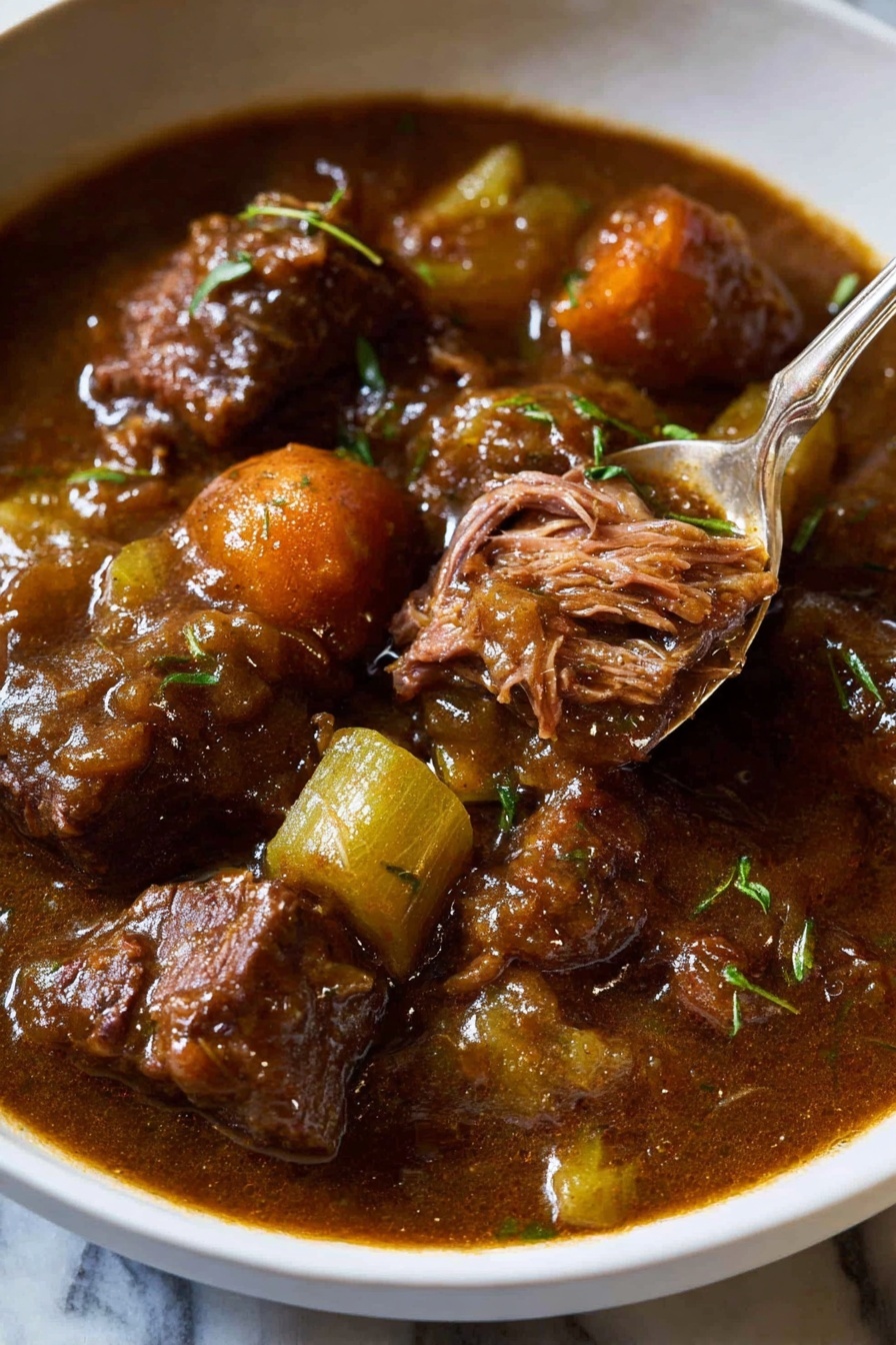 The image shows a white bowl filled with a rich brown stew consisting of large pieces of tender meat, orange carrot slices, and green celery chunks. The stew has a glossy, thick sauce coating the ingredients. One piece of meat is partially shredded, revealing its soft texture. There are small green herbs sprinkled on top of the stew. A silver spoon is resting inside the bowl, lifting some of the stew. The bowl is on a white marbled surface with a bit of sauce spilled on the bowl's edge. photo taken with an iphone --ar 2:3 --v 7 - Beef and Guinness Stew, Irish beef stew with Guinness, hearty Irish stew recipe, slow cooker beef Guinness stew, Traditional beef Guinness stew