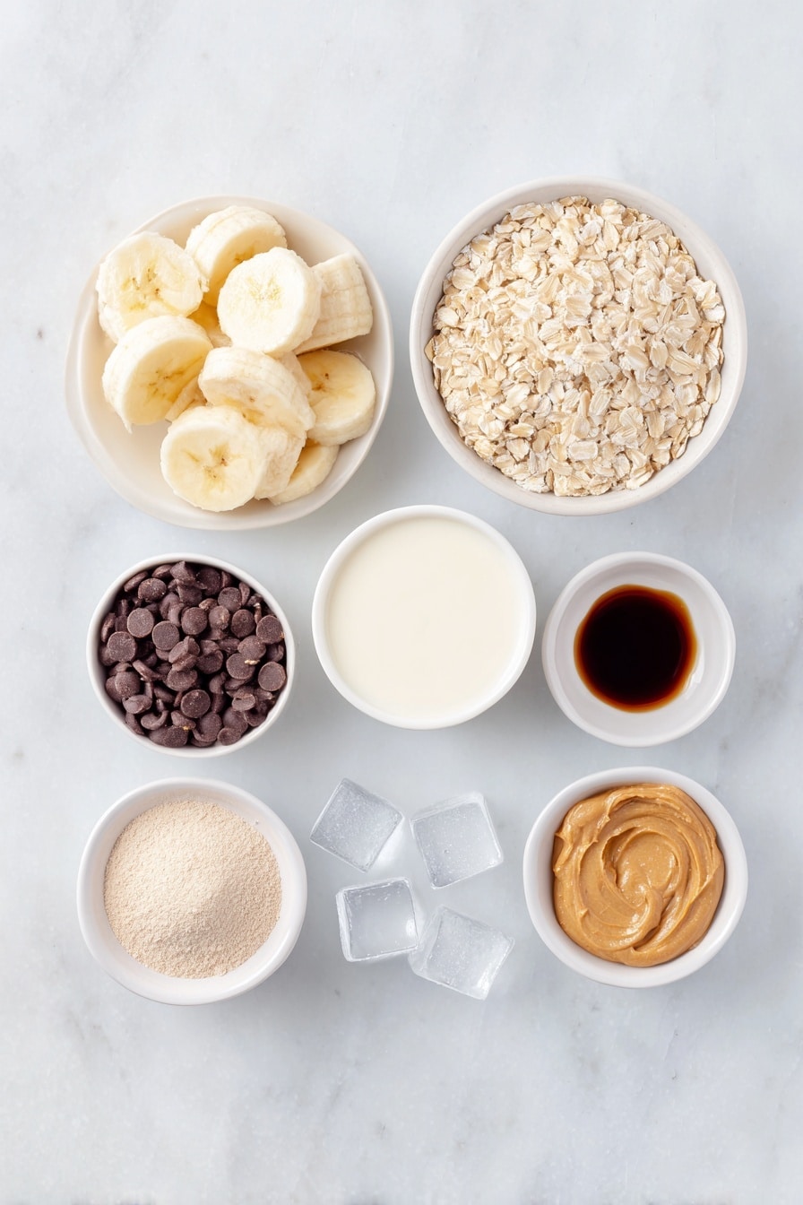 Flat lay of a peeled frozen banana sliced into chunks, a small white ceramic bowl filled with whole rolled oats, a dollop of natural peanut butter neatly placed on a white ceramic dish, a small white bowl containing unsweetened almond milk, a few clear ice cubes arranged near the bowls, a small white bowl holding vanilla protein powder, a neatly rounded heap of maca powder on a white plate, a splash of cold brew coffee shown as a small amount of dark liquid in a white bowl, and a small white bowl with glossy chocolate chips, all placed symmetrically on a clean white marble surface, soft natural light, photo taken with an iPhone, professional food photography style, fresh ingredients, white ceramic bowls, no bottles, no duplicates, no utensils, no packaging --ar 2:3 --v 7 --p m7354615311229779997 - Healthy Peanut Butter Banana Smoothie, healthy banana smoothie, nutritious peanut butter smoothie, quick healthy smoothie, wholesome breakfast drink