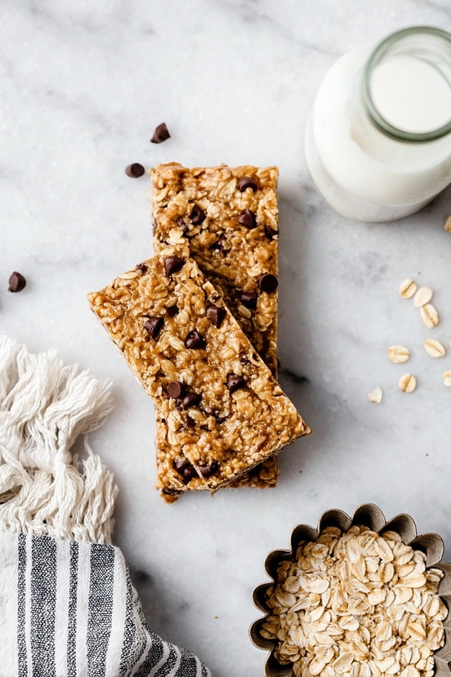 Three oatmeal chocolate chip bars are stacked in the center on a white marbled surface, showing a rough texture with visible oats and small dark chocolate chips scattered throughout each chewy tan bar. To the right side is a metal flower-shaped mold filled with plain oats, and above it is a bottle filled with white liquid, likely milk, placed near a gray and white striped towel with fringe. Photo taken with an iphone --ar 2:3 --v 7 - Homemade Peanut Butter Granola Bars, healthy snack bars, easy granola bar recipe, chewy peanut butter bars, nutritious homemade energy bars
