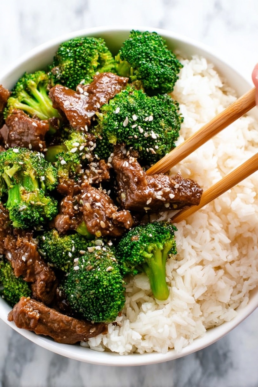 A close-up view of a dark pan filled with a rich, thick brown sauce that covers tender shredded pieces of beef and bright green broccoli florets scattered evenly throughout. In the center, a wooden spoon lifts a portion showing a mix of juicy brown beef slices and vivid green broccoli, glistening slightly under the light. The textures show the softness of the meat contrasting with the firm, fresh broccoli. The background is a white marbled texture. photo taken with an iphone --ar 2:3 --v 7 - Crockpot Beef and Broccoli, Crockpot beef and broccoli recipe, slow cooker beef and broccoli, easy Chinese Beef and Broccoli, healthy beef stir-fry