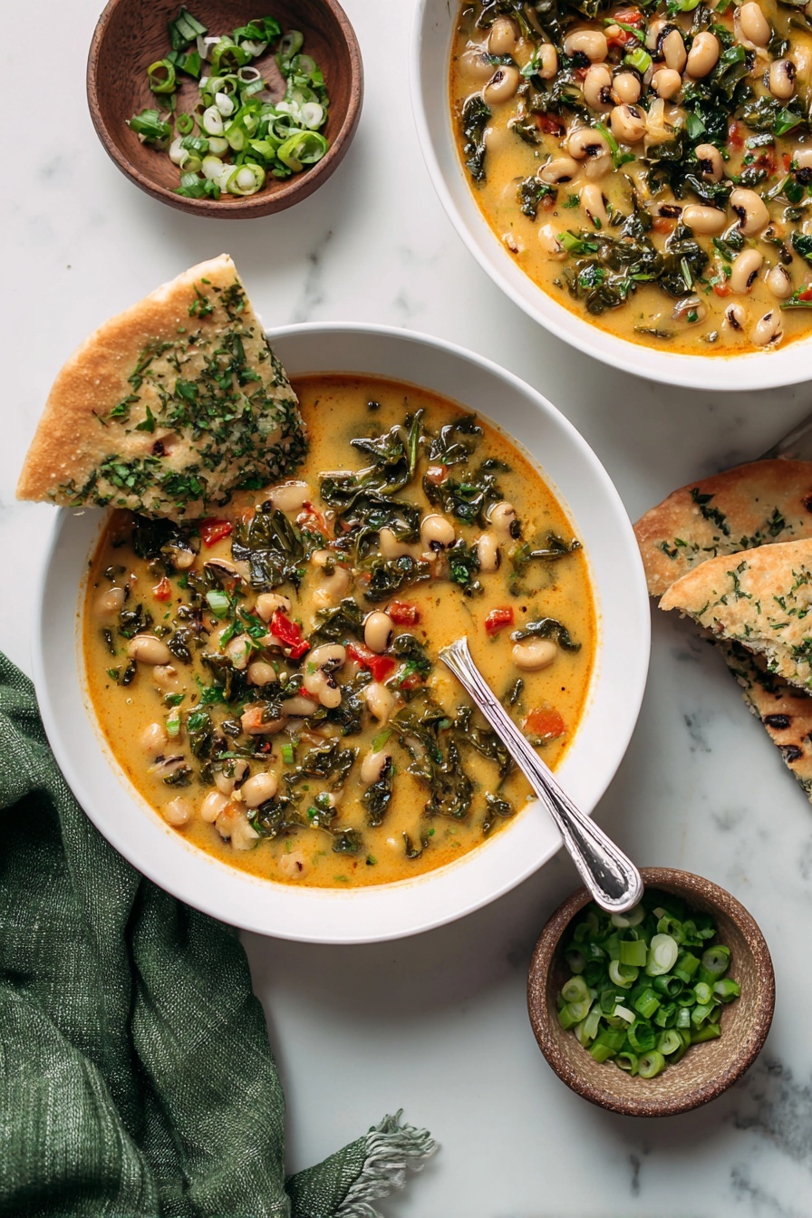 The image shows two white bowls filled with creamy soup that has black-eyed peas, dark green leafy vegetables, and small pieces of red tomatoes. Each bowl has a torn piece of flatbread with green herbs resting on the edge. A silver spoon is inside one bowl, and two small brown bowls nearby hold chopped green onions and chopped green herbs. The scene is set on a white marbled surface with a green cloth napkin partly visible. The photo is taken with an iphone --ar 2:3 --v 7 - Spicy Black-Eyed Peas and Kale Soup, hearty vegetarian soup, healthy black-eyed pea recipes, vegan comforting soups, easy spicy pea and kale soup