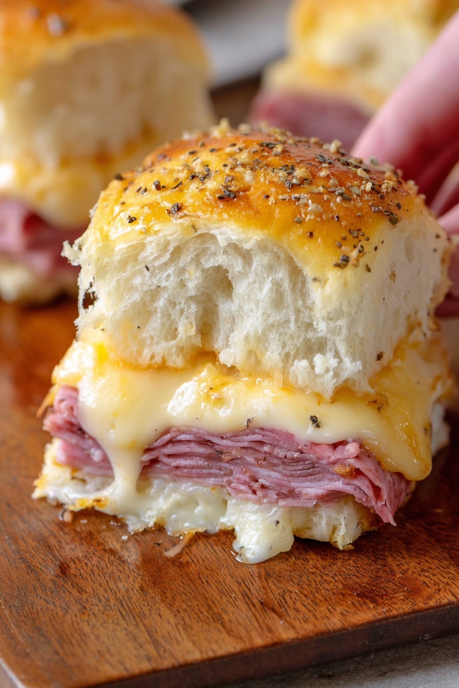 The image shows three square soft slider buns with a shiny golden-brown top sprinkled with seeds. Each slider is made of multiple layers: a soft top bun, melted white cheese, a thin folded pink ham slice, shredded light yellow cabbage or sauerkraut, and a thick fluffy white bottom bun. The sliders are placed on a wooden board with a textured look, and one slider is partially pulled apart revealing the fillings inside. At the bottom left corner, a blurred part of another slider is visible. The background is a white marbled surface. Photo taken with an iphone --ar 2:3 --v 7 - Baked Reuben Sliders, Reuben sliders, Reuben sandwich sliders, appetizer sliders, party finger foods